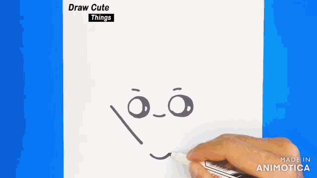a person is drawing a face with a marker on a piece of paper