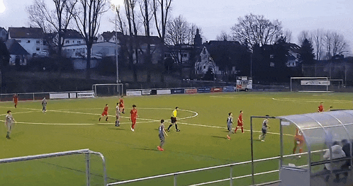 a group of soccer players are playing on a field with a sign that says " allianz "