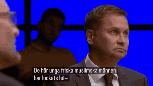 a man in a suit and tie says tank henrik tank in a foreign language