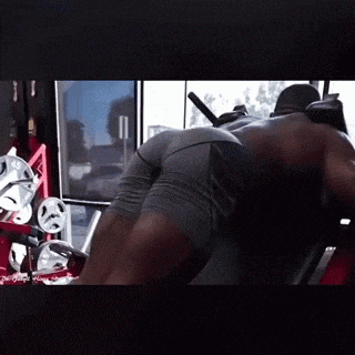 a man is using a machine in a gym to do exercises .