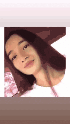 a close up of a woman 's face with a white shirt on