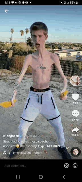 a man with a tattoo on his chest that says longneck is standing on the beach