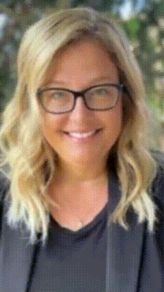 a woman wearing glasses is smiling and wearing a black shirt