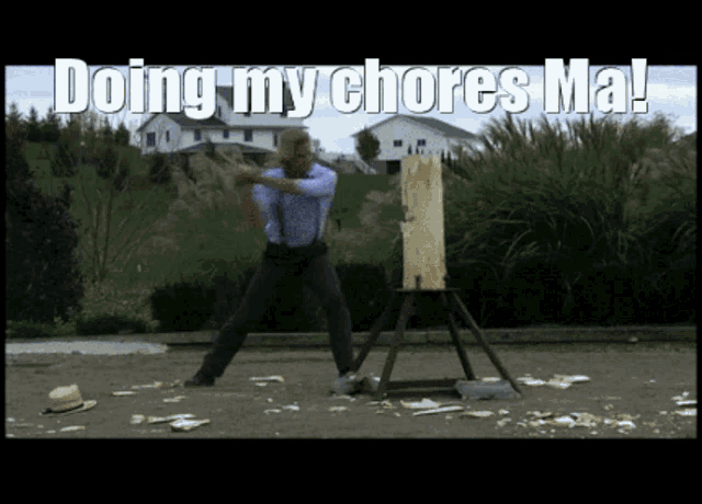 a man is standing in front of a stump with the words doing my chores ma written above him