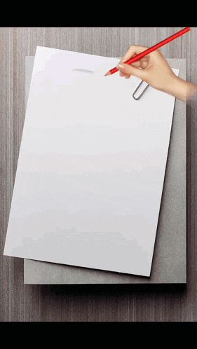 a hand is holding a pencil over a piece of paper