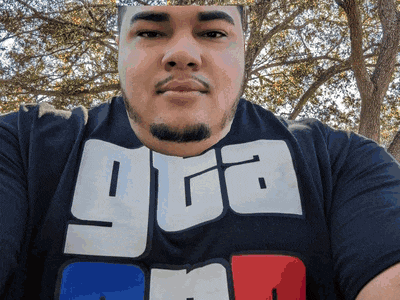 a man with a beard wears a shirt that says gga on it