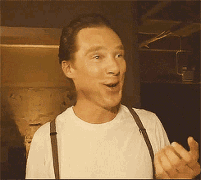 a man wearing suspenders and a white shirt is making a surprised face