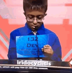 a person holding a sign that says 132 dev on it