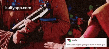 a person is holding a gun in their hand and another person is holding another gun in their hand .