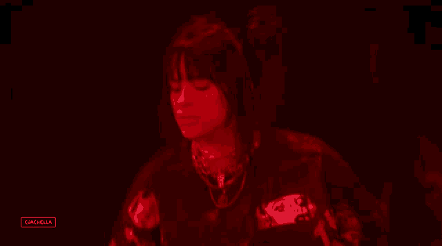 a blurred image of a person in a red light with the word cancella below