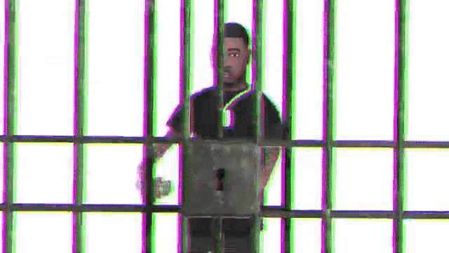 a man is standing behind bars in a jail cell with a key in his hand .