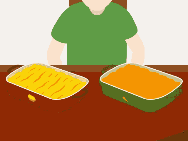 a man sits at a table with two casserole dishes of food on it