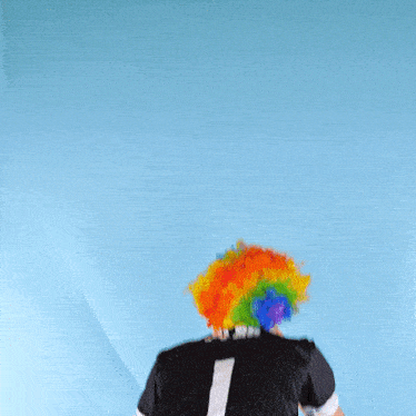 a man wearing a clown wig and a black jersey with the number 1 on the back