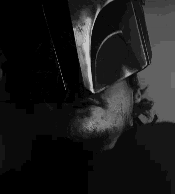 a black and white photo of a man with a broken nose and a hole in his nose .