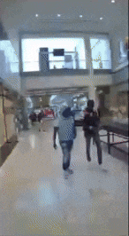 a blurry image of people walking in a mall