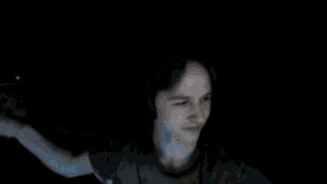 a blurry picture of a man 's face with a hand behind him