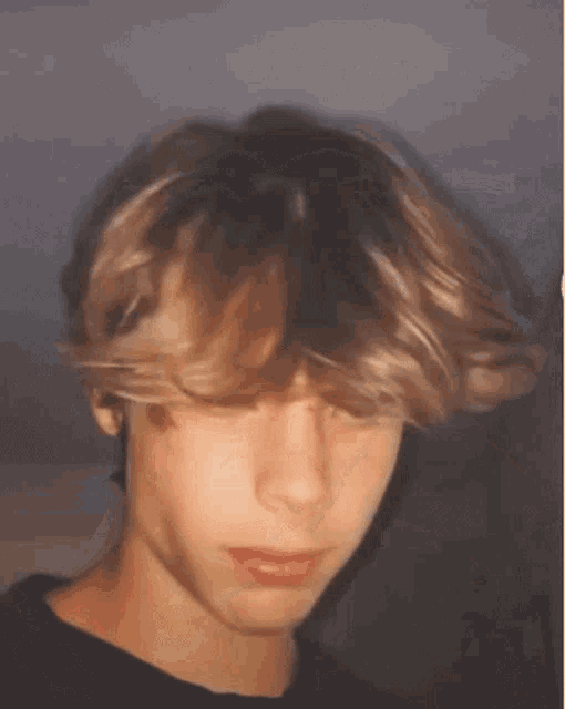 a close up of a young man 's face with a blurry background