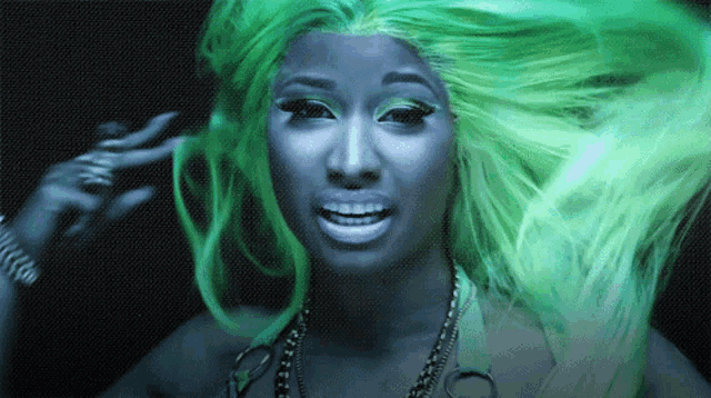 a woman with green hair and a blue face