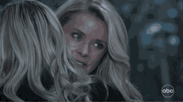 two women are looking at each other with abc written on the bottom