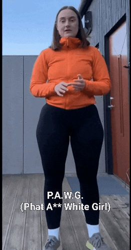 a woman in an orange jacket and black pants is standing on a wooden deck with the caption p.a.w.g.