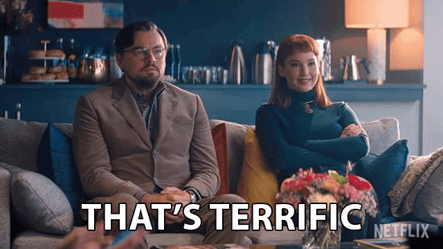 a man and a woman sit on a couch with the words that 's terrific written on the bottom