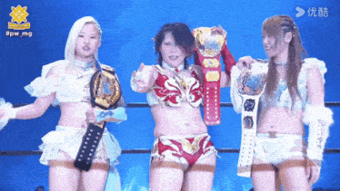 three female wrestlers are posing for a picture with the hashtag #pw_mg on the bottom right