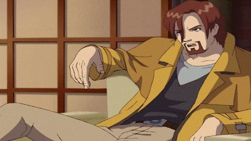 a man with red hair and a beard is sitting on a couch