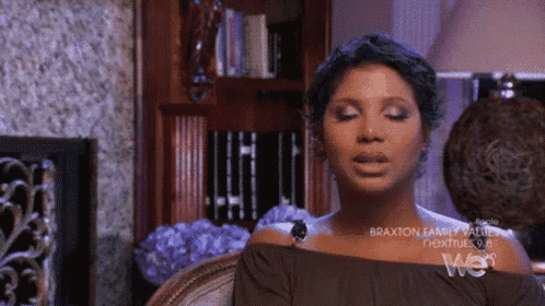 a woman sitting in a chair with braxton family values next tuesday on the screen