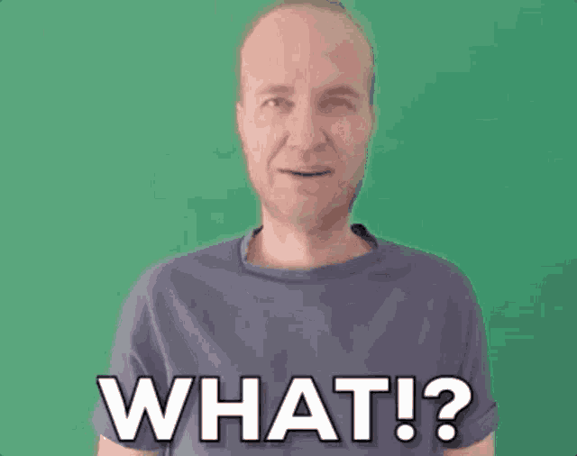 a man in a blue shirt is making a funny face and saying `` what ! ''