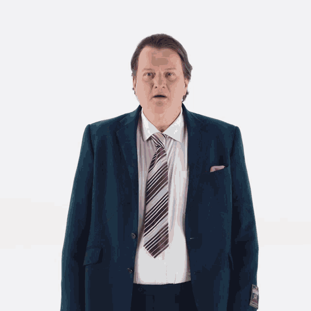 a man wearing a suit and tie is making a funny face