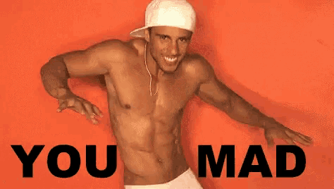 a shirtless man is dancing in front of an orange background with the words you mad written on it