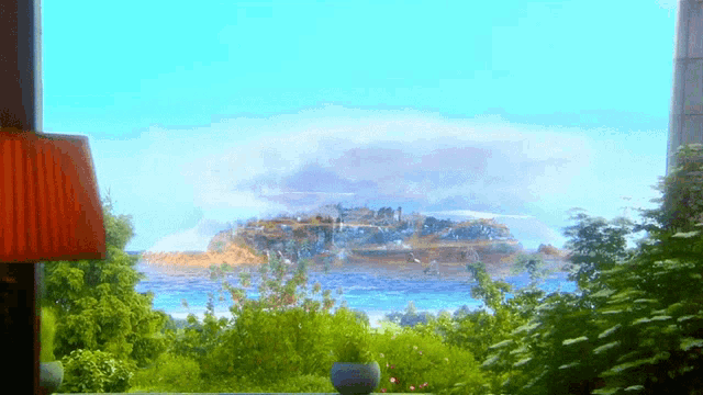 a view of a large island in the ocean from a window