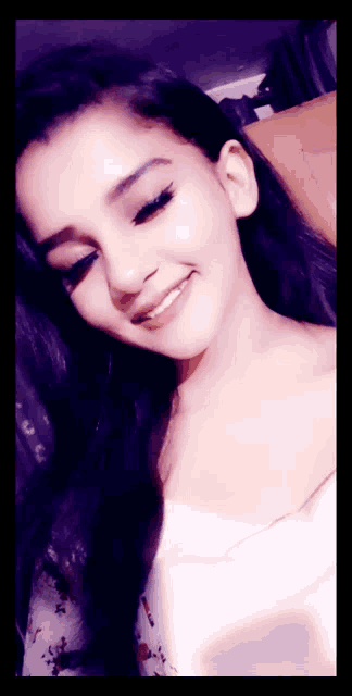 a close up of a woman 's face with a smile on her face