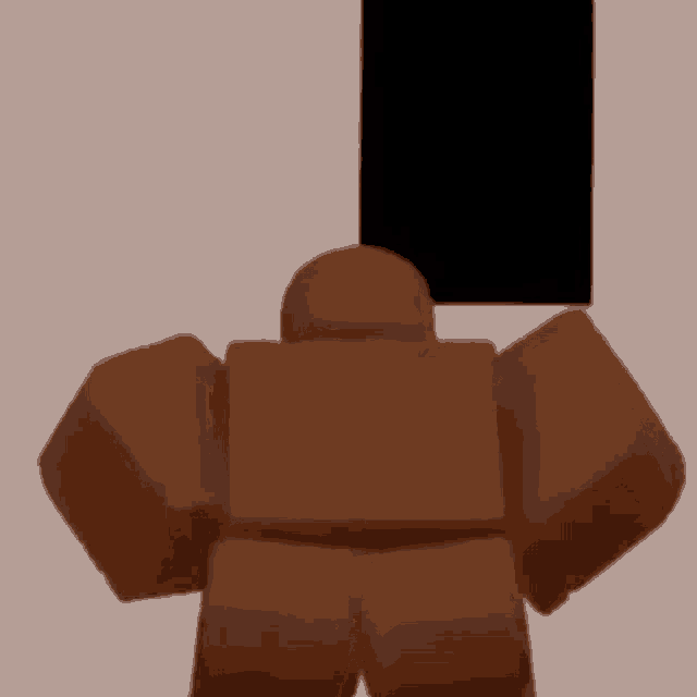 a brown robot is standing in a room with a black box in the background .