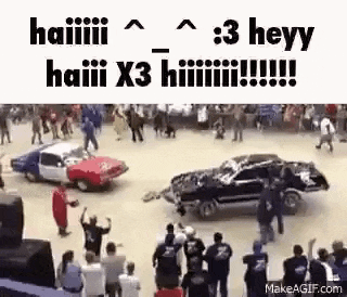 a group of people are watching a car racing on a dirt track .
