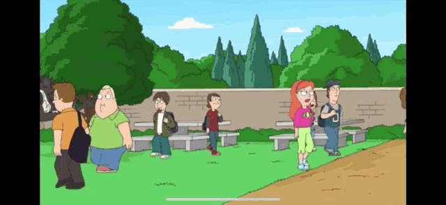 a group of people are standing in a park with trees in the background