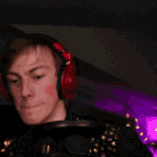a man wearing headphones is holding a microphone