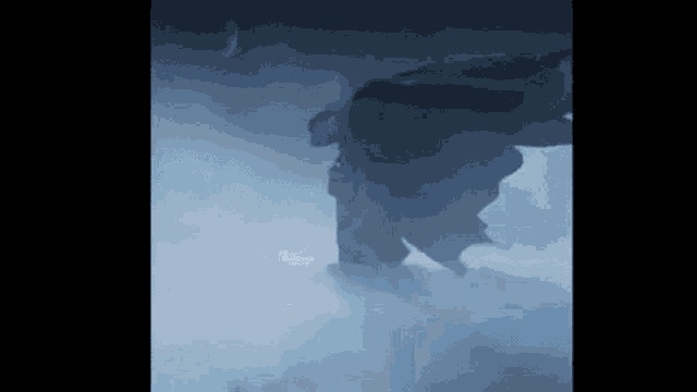 a person is standing in the middle of a foggy room .