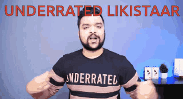 a man wearing an underrated t-shirt is giving a thumbs up