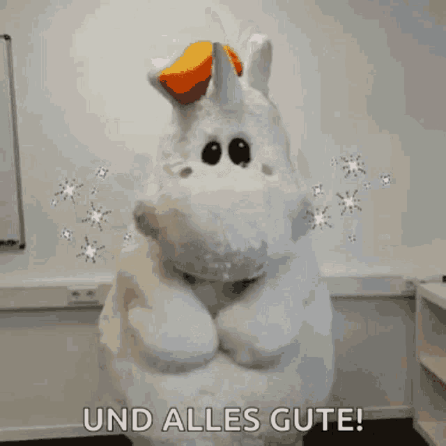 a stuffed unicorn with the words und alles gute written on it