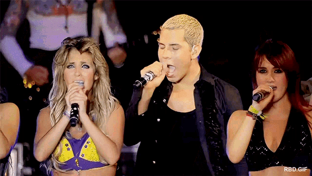 a group of people singing into microphones with the words rbd gif visible in the corner
