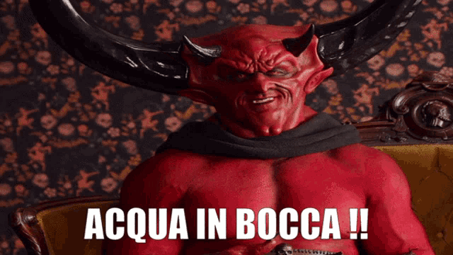 a devil with horns is sitting on a couch with the words acqua in bocca written below him