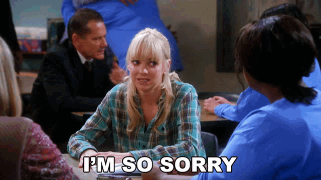 a woman sitting at a table with the words " i 'm so sorry " above her