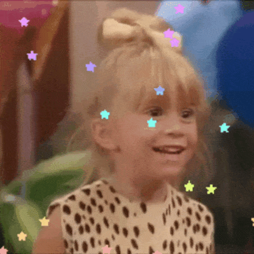 a little girl wearing a leopard print dress is smiling with stars coming out of her hair