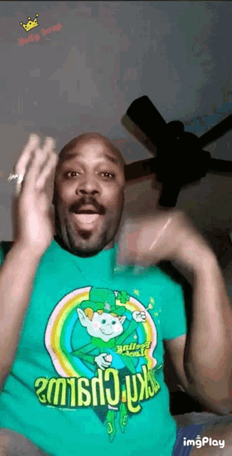 a man is wearing a green shirt with a leprechaun on it .