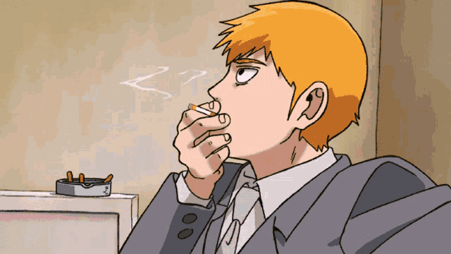a man in a suit is smoking a cigarette next to an ashtray