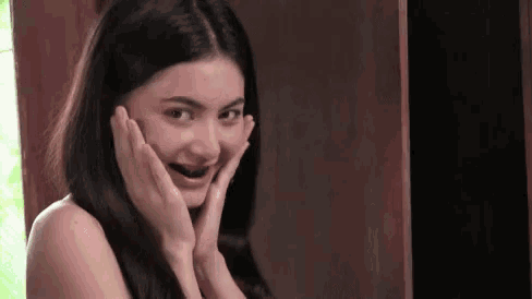 a young woman with braces on her teeth is making a funny face .