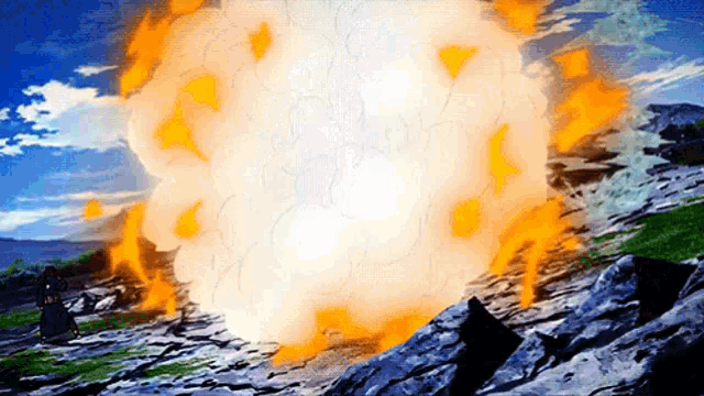 a large explosion is going off in the middle of a rocky area .