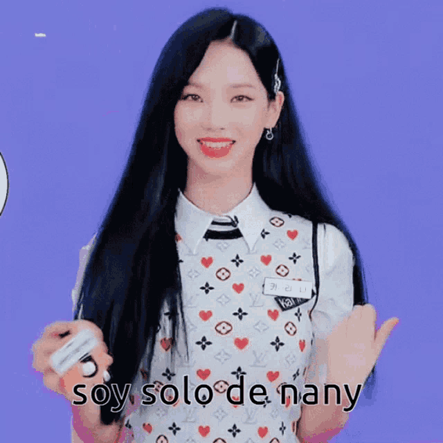 a girl with long black hair is wearing a louis vuitton vest and tie