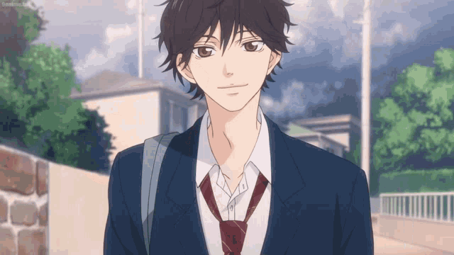 a boy in a suit and tie is walking down a street .